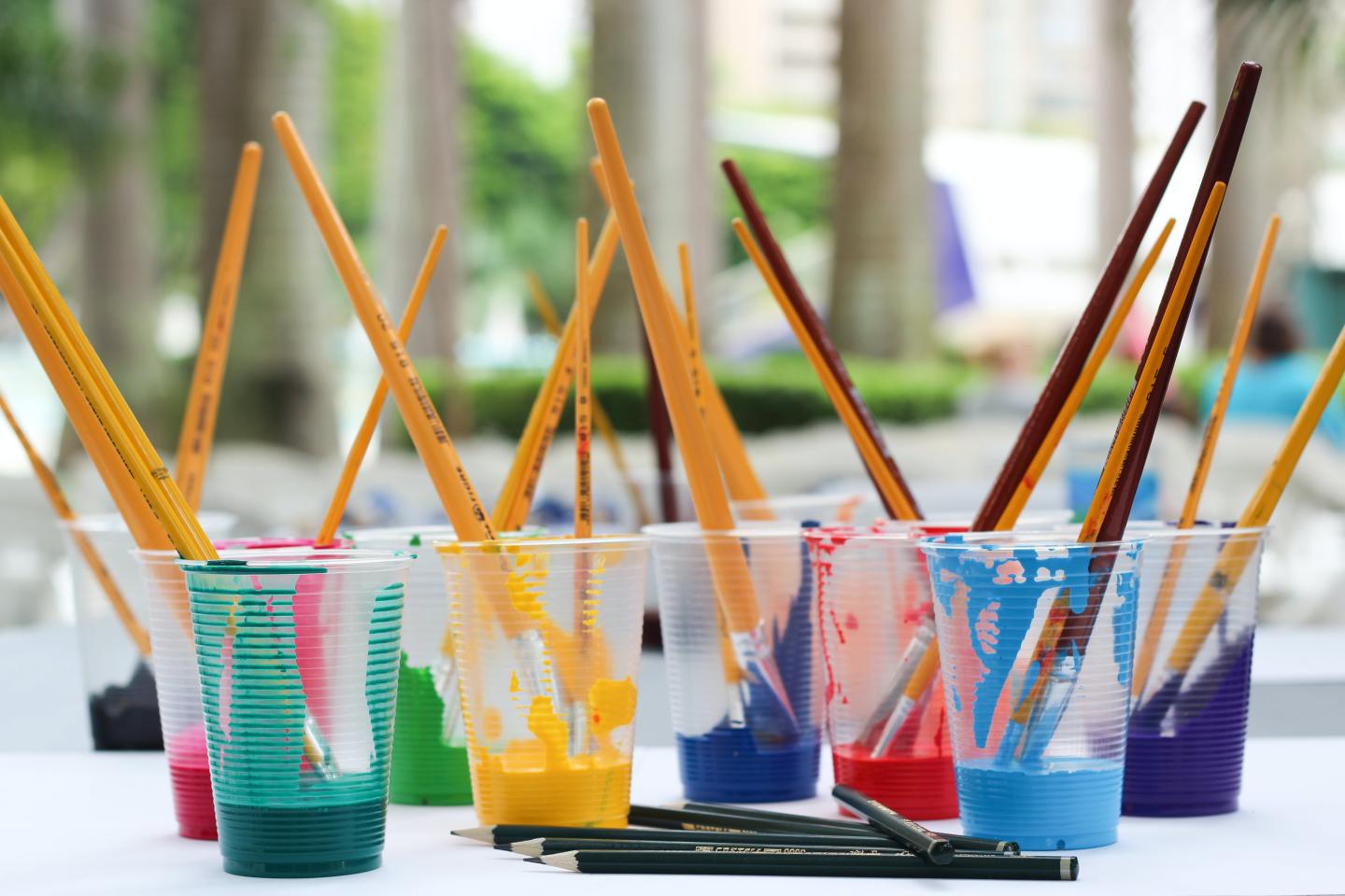 Paint brushes in plastic cups